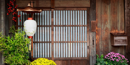 Traditional japanese style lantern decoration in front of wooden door.の写真素材