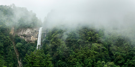 waterfall in the mountains with fog and mist, beautiful photo digital pictureの写真素材