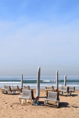 Sunshade and sunlounger on the beachの写真素材
