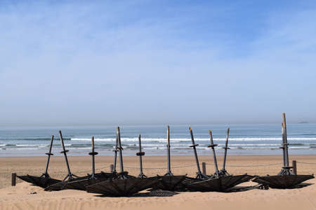 Sunshades lying downside down on the beachの写真素材