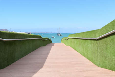Bridge on the sea with green leaves at the sideの写真素材