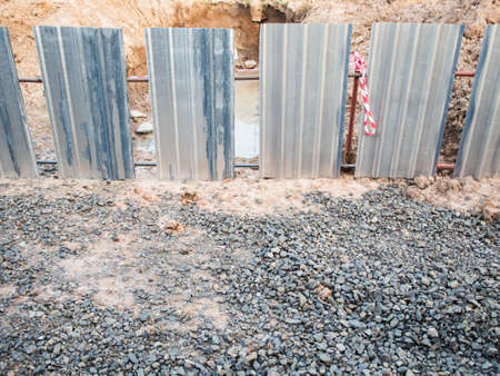 zinc wall intercept construction area dig a puddle holeの写真素材