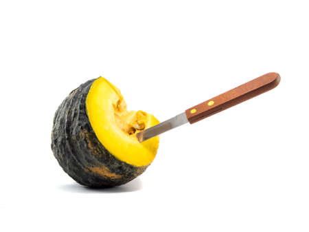 a knife stab equal part pumkin on white background2の写真素材