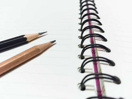 black pencil and wooden pencil and book hoopの写真素材