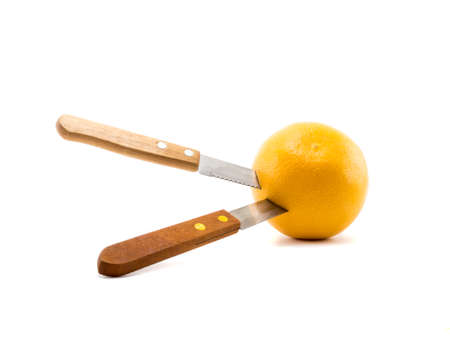 knife stab orange on isolated white backgroundの写真素材