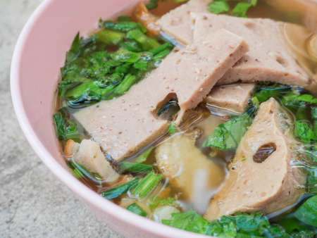 close up ekaehla one bowl put pork of meatballs, pork slices, coriander in a bowl of pinkの写真素材