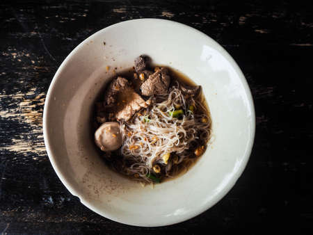 noodles of thicken Soup put rice Vermicelli and meatballs in bowl of whiteの写真素材