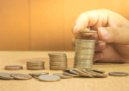 Saving money concept preset by hand putting money coin stack growing business