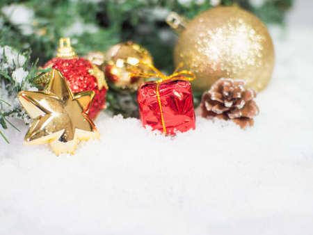 Gold christmas balls and star and red box in the snow. Copy and paste for background,  Concept decoration of christmasの写真素材