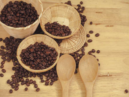 coffee bean in little basket and spoon wood on slat woodの写真素材