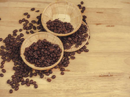 coffee bean in little basket on slat woodの写真素材