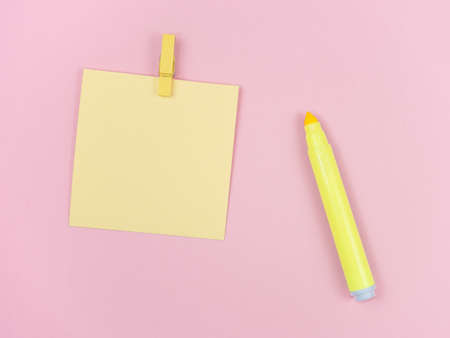 yellow magic pen and paper note and paperclip on pink background, minimal concept and similarities differencesの写真素材