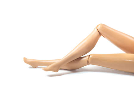 The beautiful slender legs of pretty figure girl doll doing gestures sexy isolated on white backgroundの写真素材
