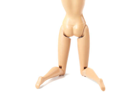 The beautiful slender legs of pretty figure girl doll doing gestures sexy isolated on white backgroundの写真素材