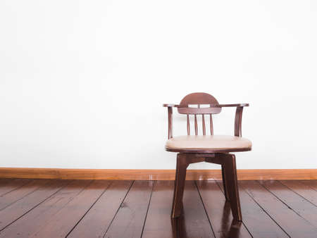 Vintage chair in white room interior on parquet wood floor.の写真素材