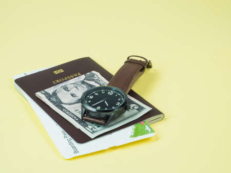 Concept go travel holiday, Vacations plan Boarding pass and passport, bank note, Watch, go tourist on yellow backgroundの写真素材