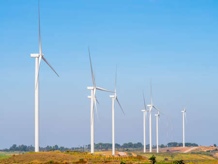 Landscape Wind turbines generating electricity with blue sky and mountain