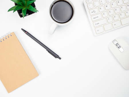 Modern white office desk table with keyboard computer, coffee and other office supplies of...