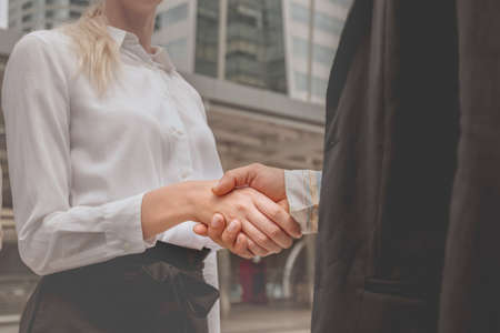 Business person makes confidence trust by shake hands. Building trust between businesses and partnership. Business partnership and shake hands concept.の写真素材