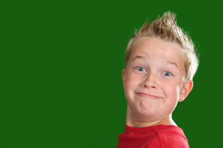 happy boy in front of green backgroundの写真素材