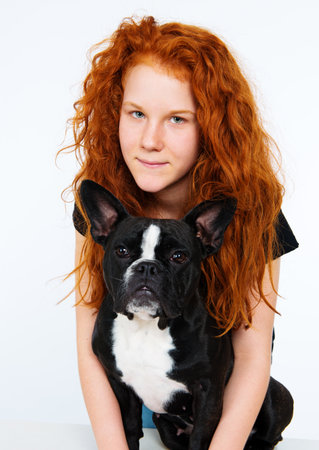 red-haired girl with french bulldogの写真素材