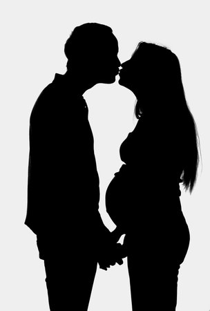 young couple expecting a baby- silhouetteの写真素材