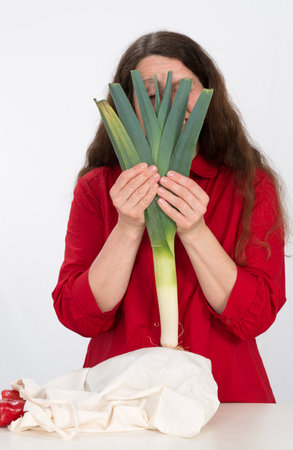 woman in kitchen behind  leek