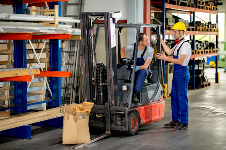two worker with pallet transporter in factory