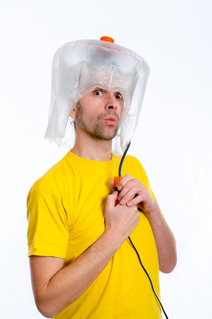 crazy white man man with hair dryerの写真素材