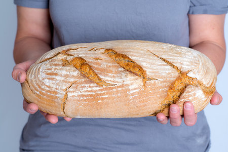 long delicious self made breadin womans hands
