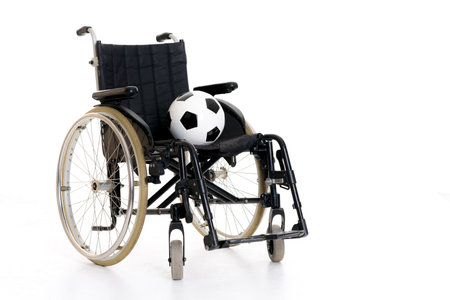 wheelchair with ball in front of white backgroundの写真素材