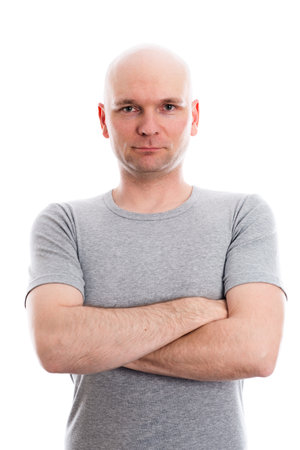 man with bald head in gray shirt is looking in to the cameraの写真素材