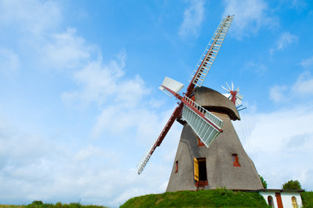 old historic windmill in front of blue sky