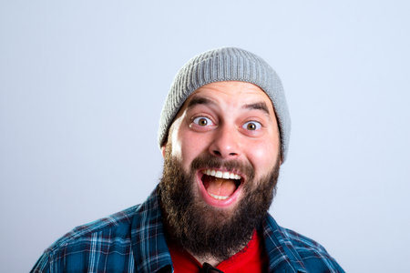 young bearded man lokking amazed in to the cameraの写真素材