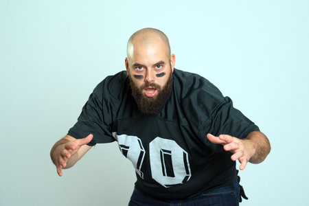 bearded american football player is looking in to the camera