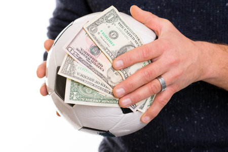 male hands with soccer- ball and moneyの写真素材