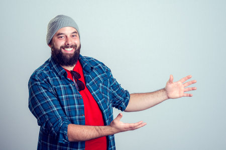 young bearded man is pointing to the side