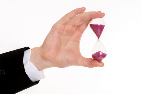 businessmans hand with hourglass in front of white background