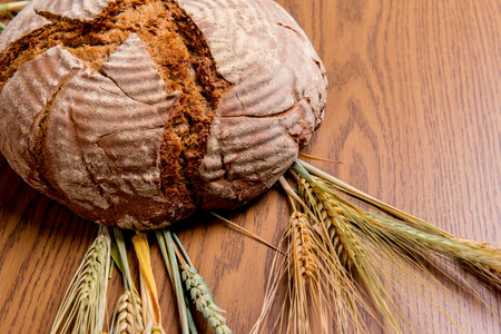round bread with cereals on wooden ground
