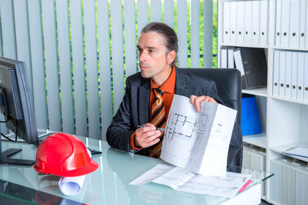 young architect working at his desk in officeの写真素材