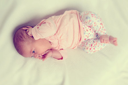 sweet baby lying on bright ground