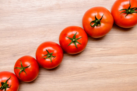 red tomatoes on wooden ground from aboveの写真素材