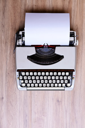 old typewriter on wooden ground from aboveの写真素材