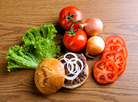 home made hamburger with meat, salad, onion, tomatoの写真素材