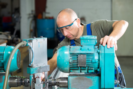 one worker in factory on the machine