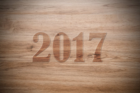 new year- 2017 on brown wooden groundの写真素材