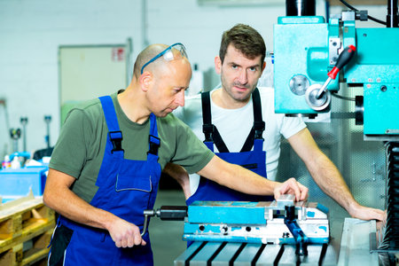 two worker in factory on the machine