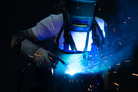 man welding metal in the factoryの写真素材