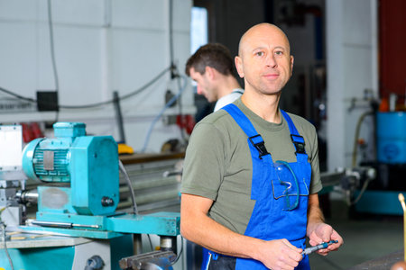 one worker in factory on the machine