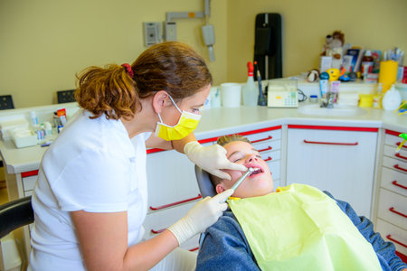 A teenager at a female dentist's surgeryの写真素材
